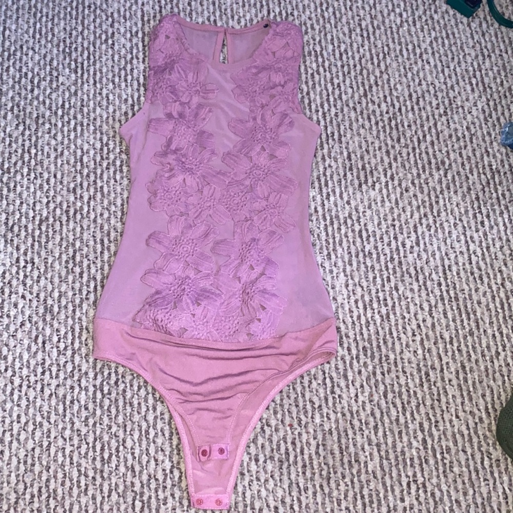 A flower patter lace body suit, worn a few times. In wonderful condition.